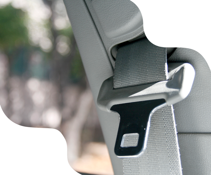 Seatbelt buckle in a car, gray fabric, buckle in a silver metal.