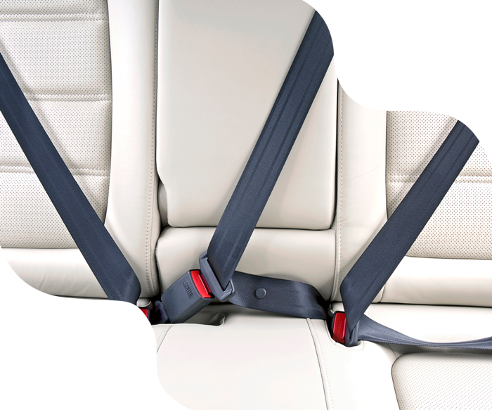 Car's rear seat with three dark blue seatbelts against a light-colored leather interior.