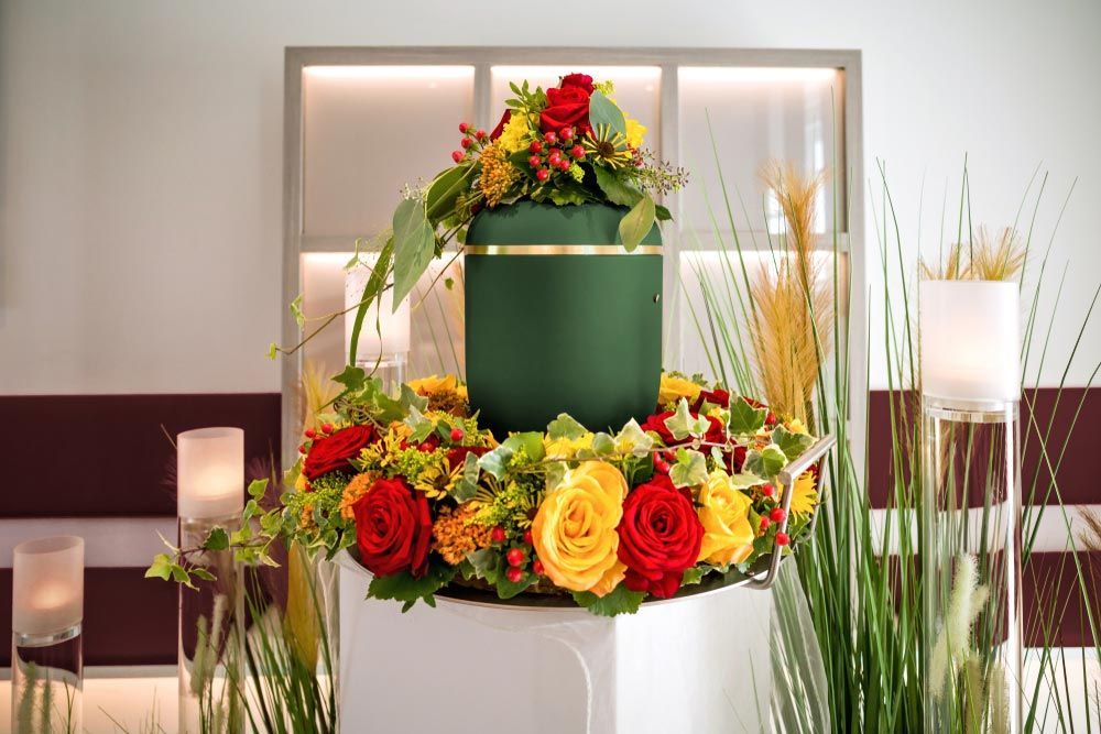 A Green Urn is Surrounded by Flowers in a Room — Castletown Flower Hut in Pimlico, QLD