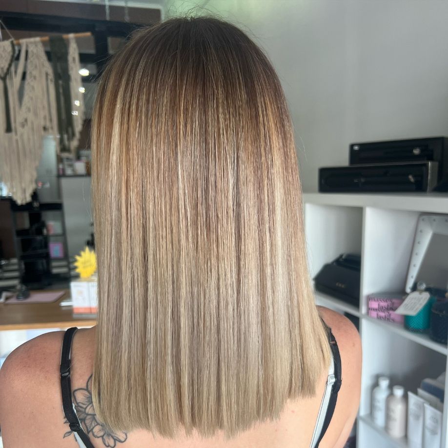 The Back of A Woman 's Head with Long Hair and A Tattoo — Ammo Hair and Beauty In Maclean, NSW