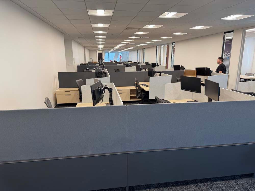 A large office with a lot of cubicles and computers.