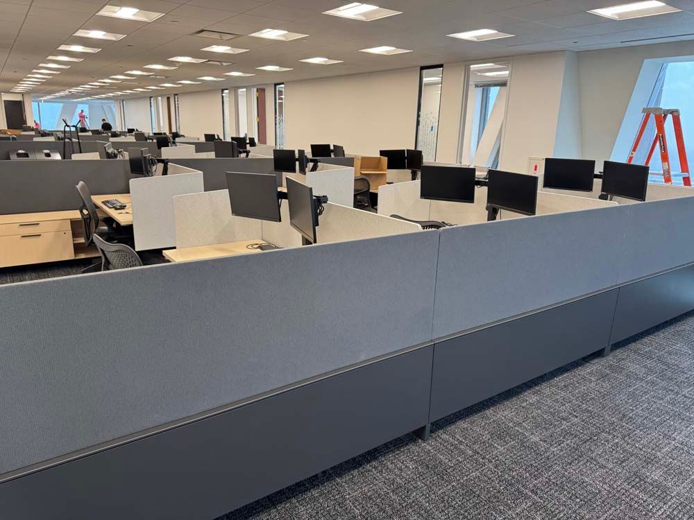 A large office with a lot of cubicles and desks