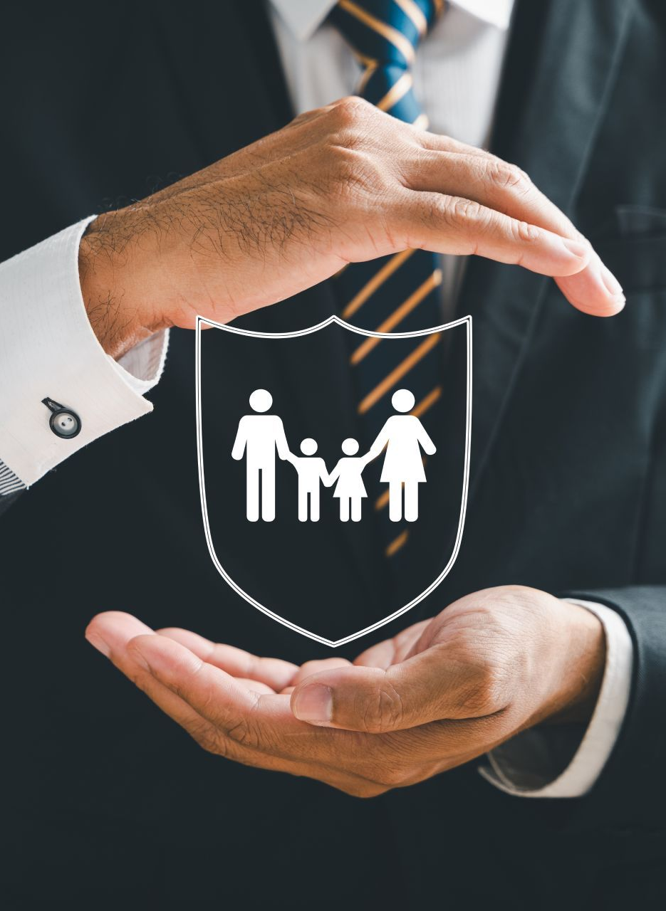 Hands of a man in suit protect family symbol within a shield, symbolizing protection.