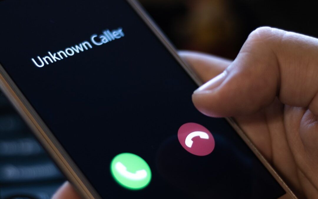 Hand holding phone showing an incoming call from an