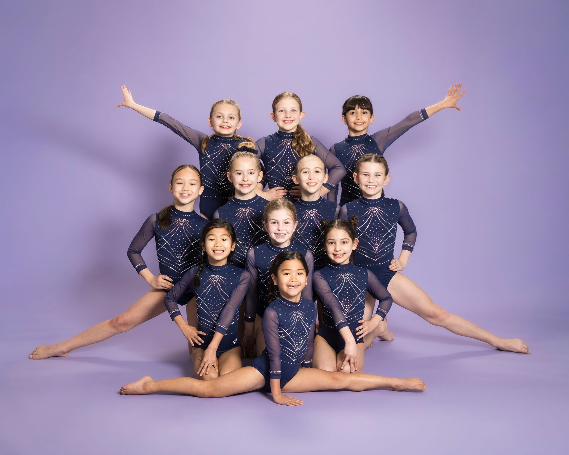 A group of young girls are posing for a picture together.