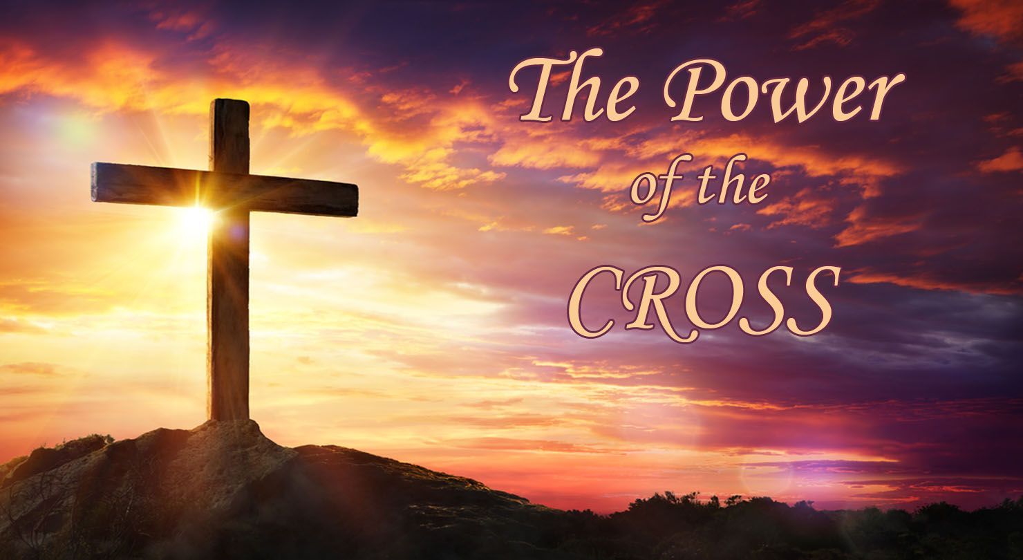 Cross silhouetted on a hill against a sunset with 