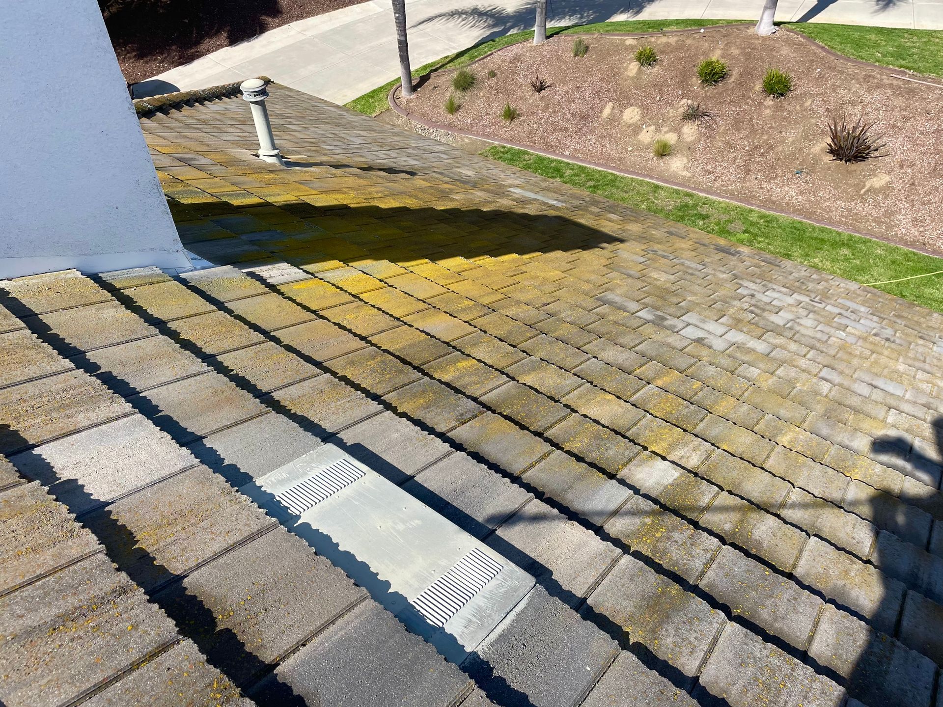 A person is cleaning a patio with a pressure washer.