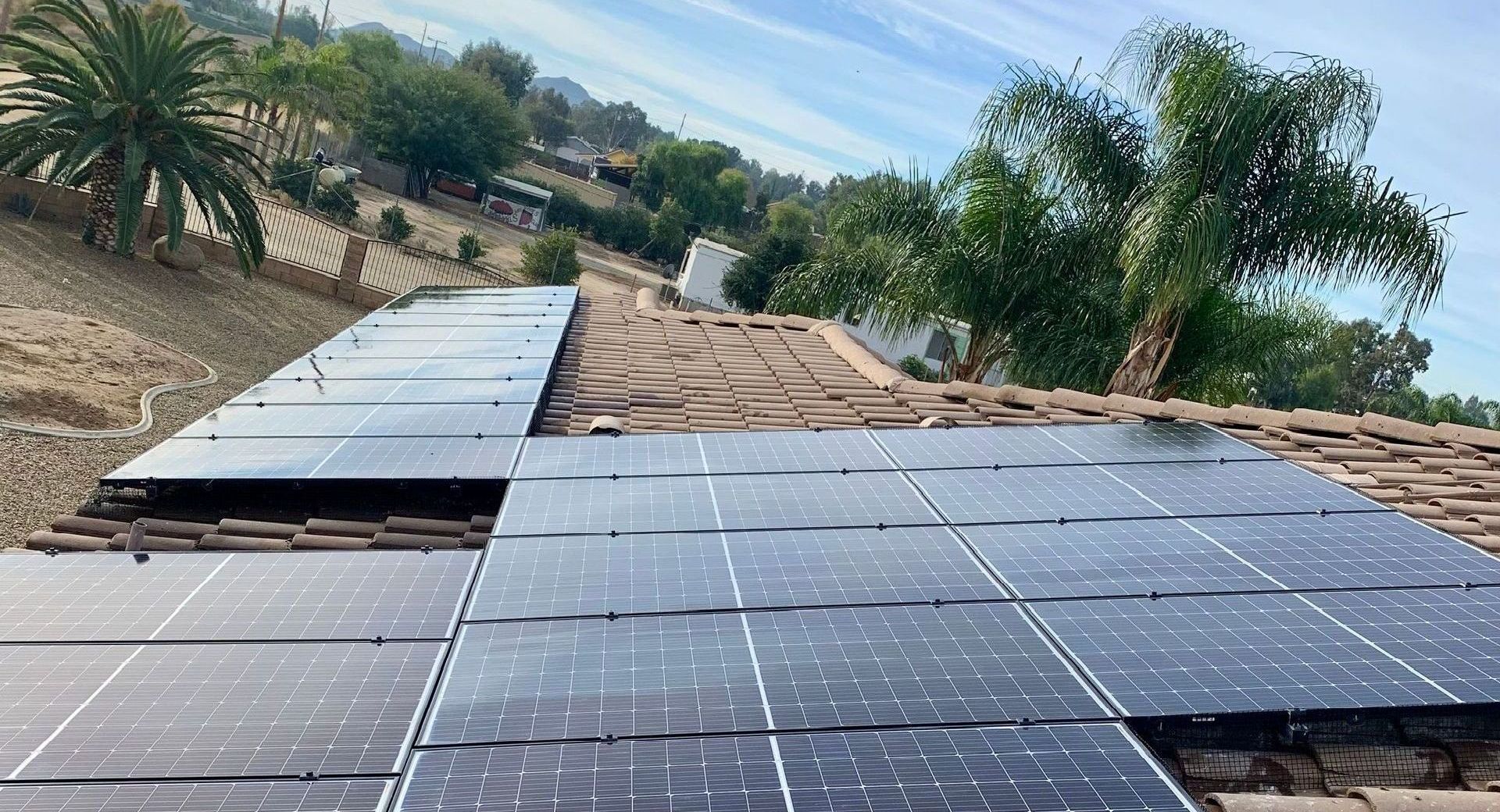 there are many solar panels on the roof of a house .