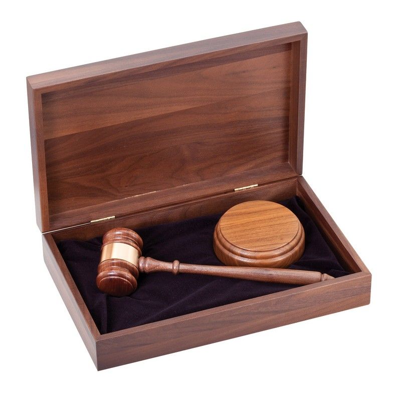 A wooden box with a wooden gavel in it