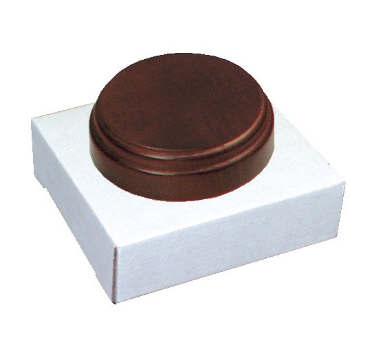 A round brown object is sitting on top of a white box