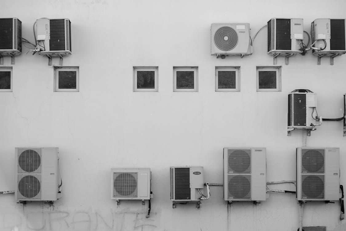 Industrial air conditioning units mounted outdoors against a wall