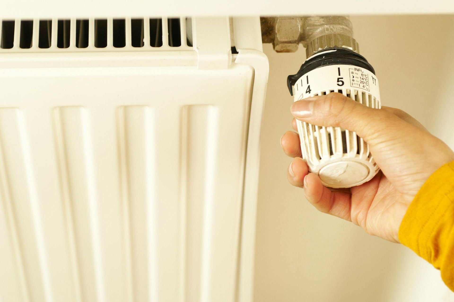 Picture shot of a person increasing the temperature of the heater.