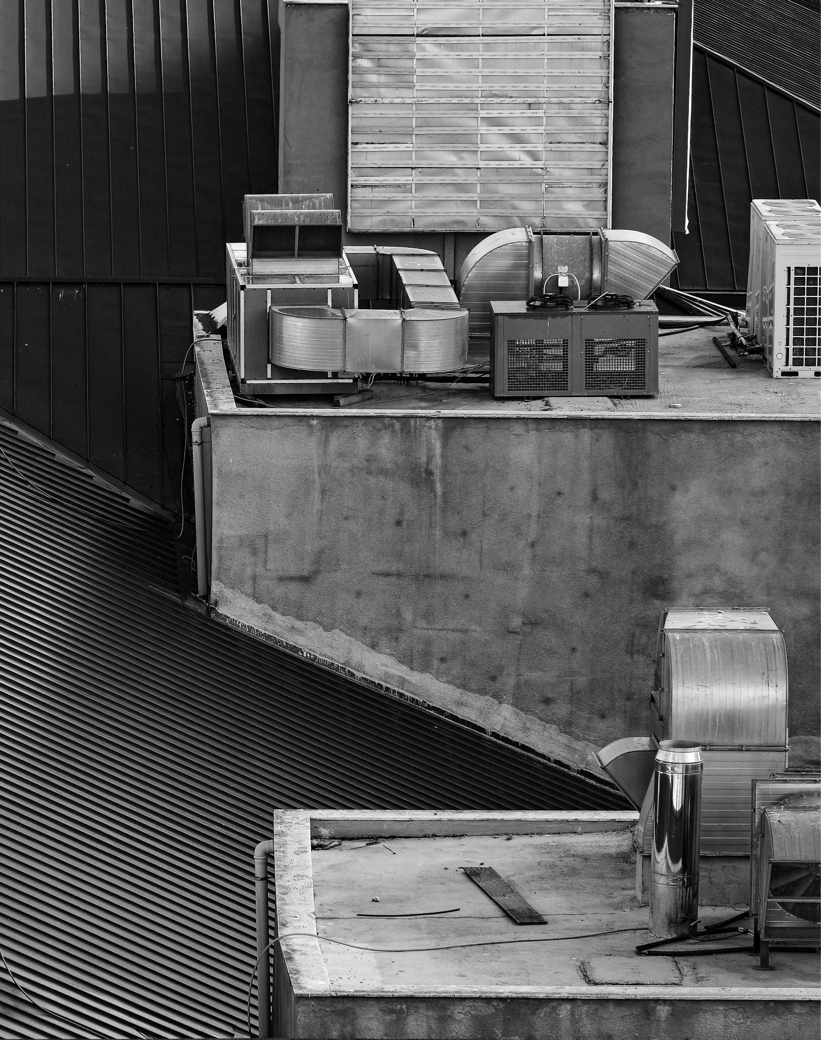 View of rooftop air conditioning units and structures in monochrome.