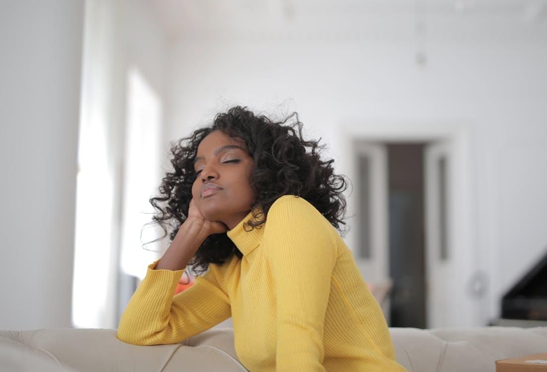 A woman relaxes indoors.