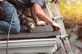worker ladder pressure washing home prior painting