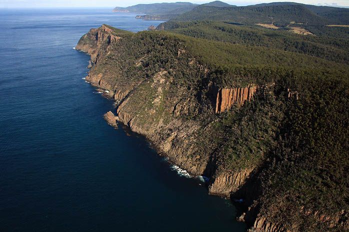An aerial view of a cliff overlooking the ocean.