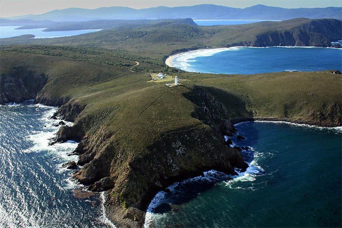 An aerial view of a cliff overlooking a body of water