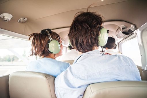 A young couple enjoying aerial views during a scenic flight adventure tour.