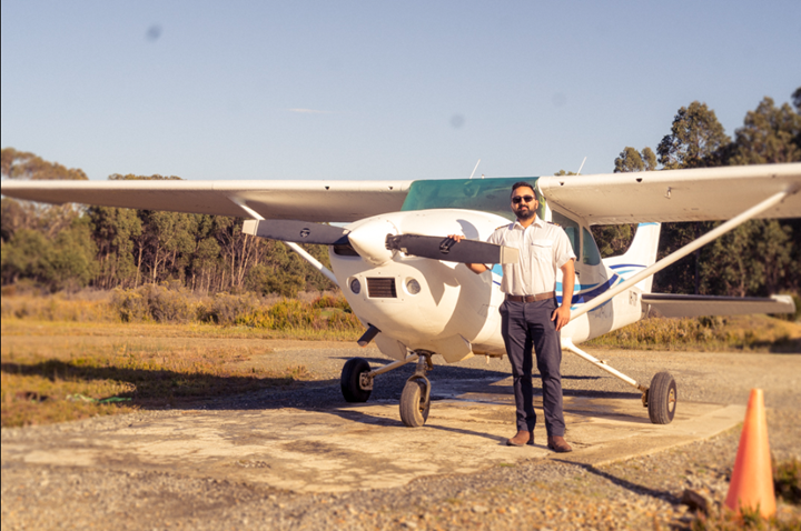 Cessna 182 with a pilot on the side and Trees behind. Cessna 182 with a pilot on the side and Trees behind.