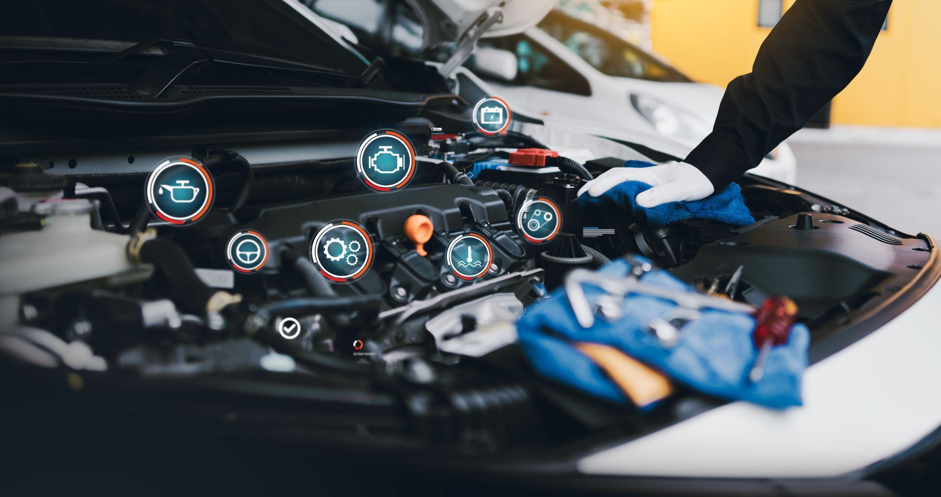 Mechanic inspecting a car engine with highlighted components and tools on a workbench