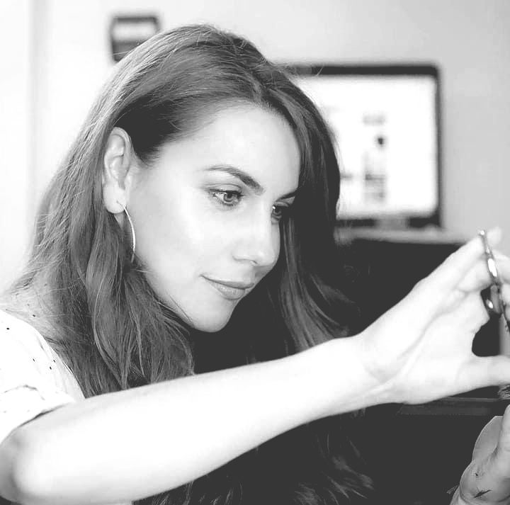 A woman is holding a key in her hand in a black and white photo.
