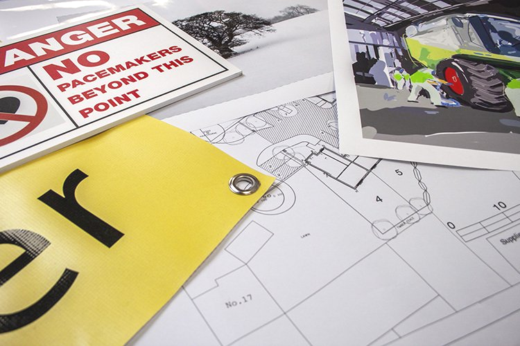A selection of large format printed items, including: plan print, banner with eyelets, foamex sign, artist prints