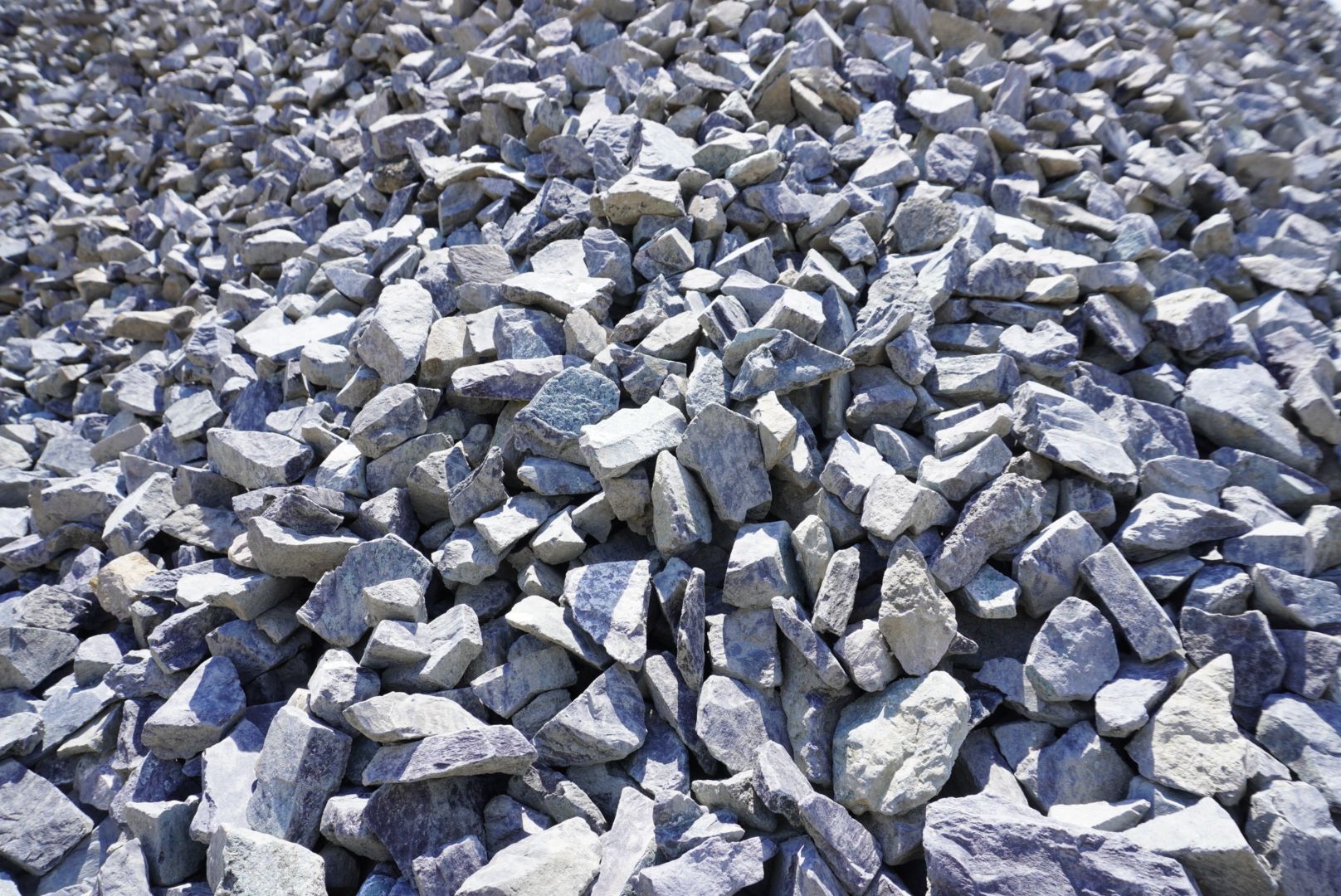 Pile of gray and white crushed rocks or gravel filling the frame.