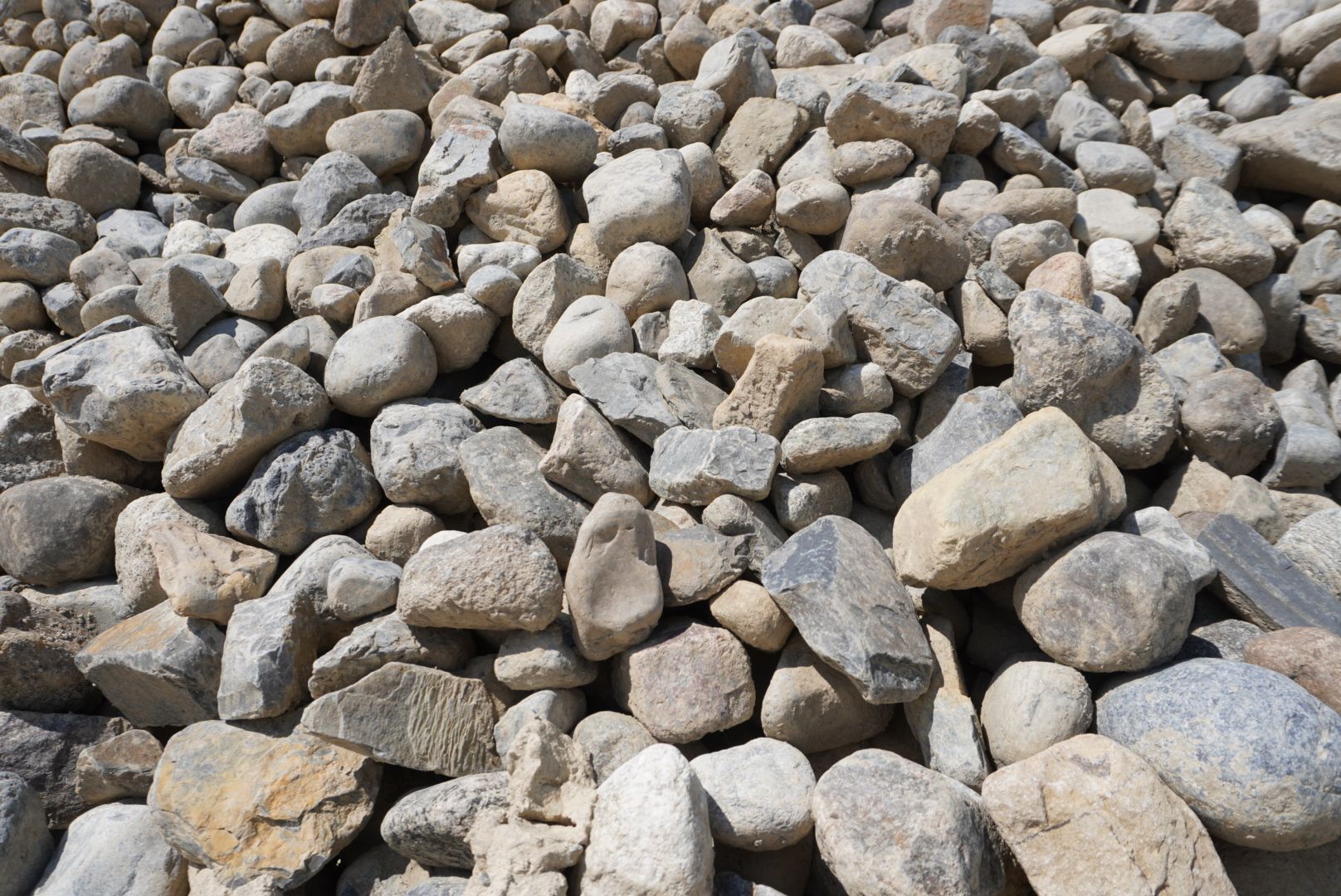 Pile of light gray rocks and stones filling the frame