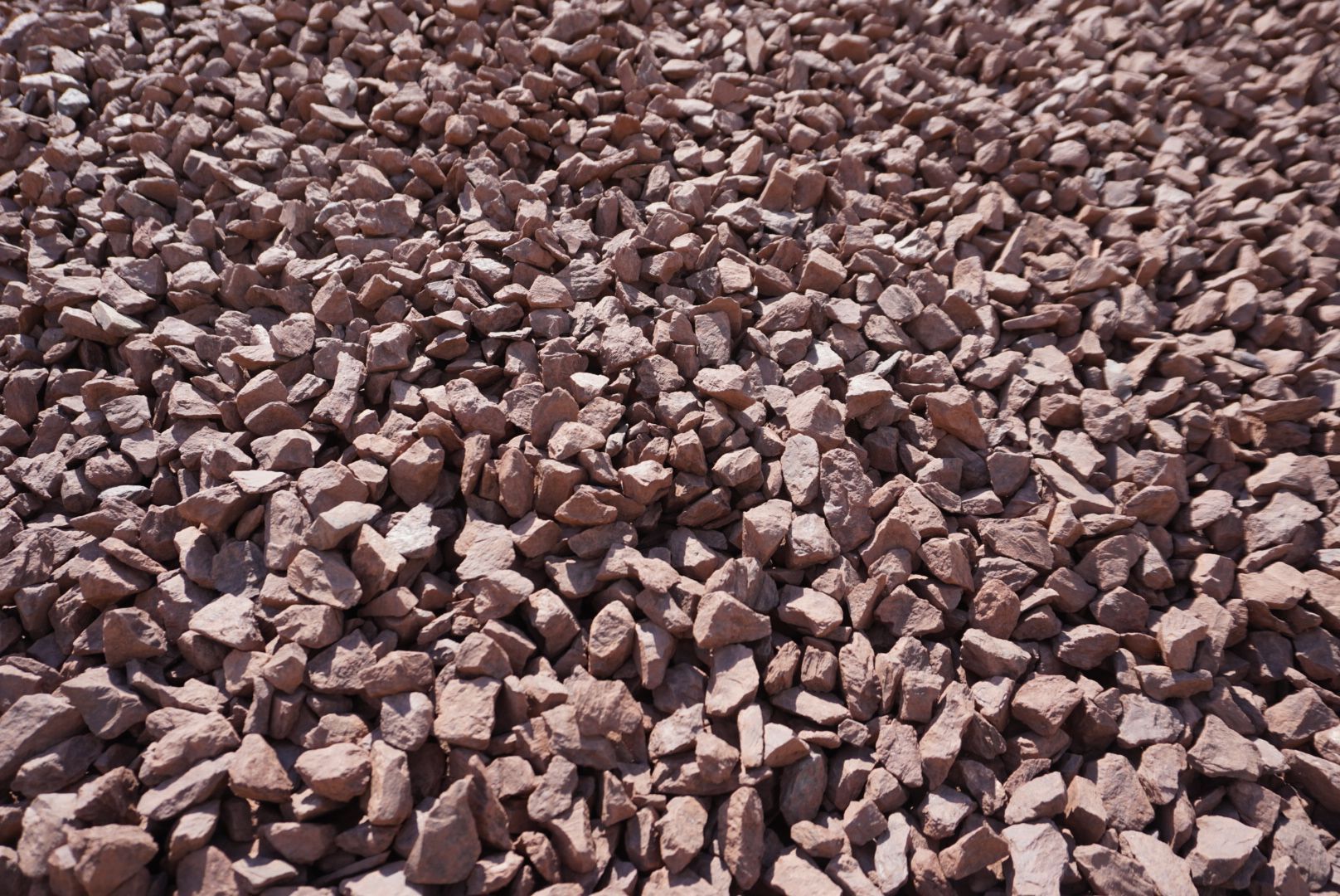 Pile of small reddish-brown rocks or gravel filling the frame
