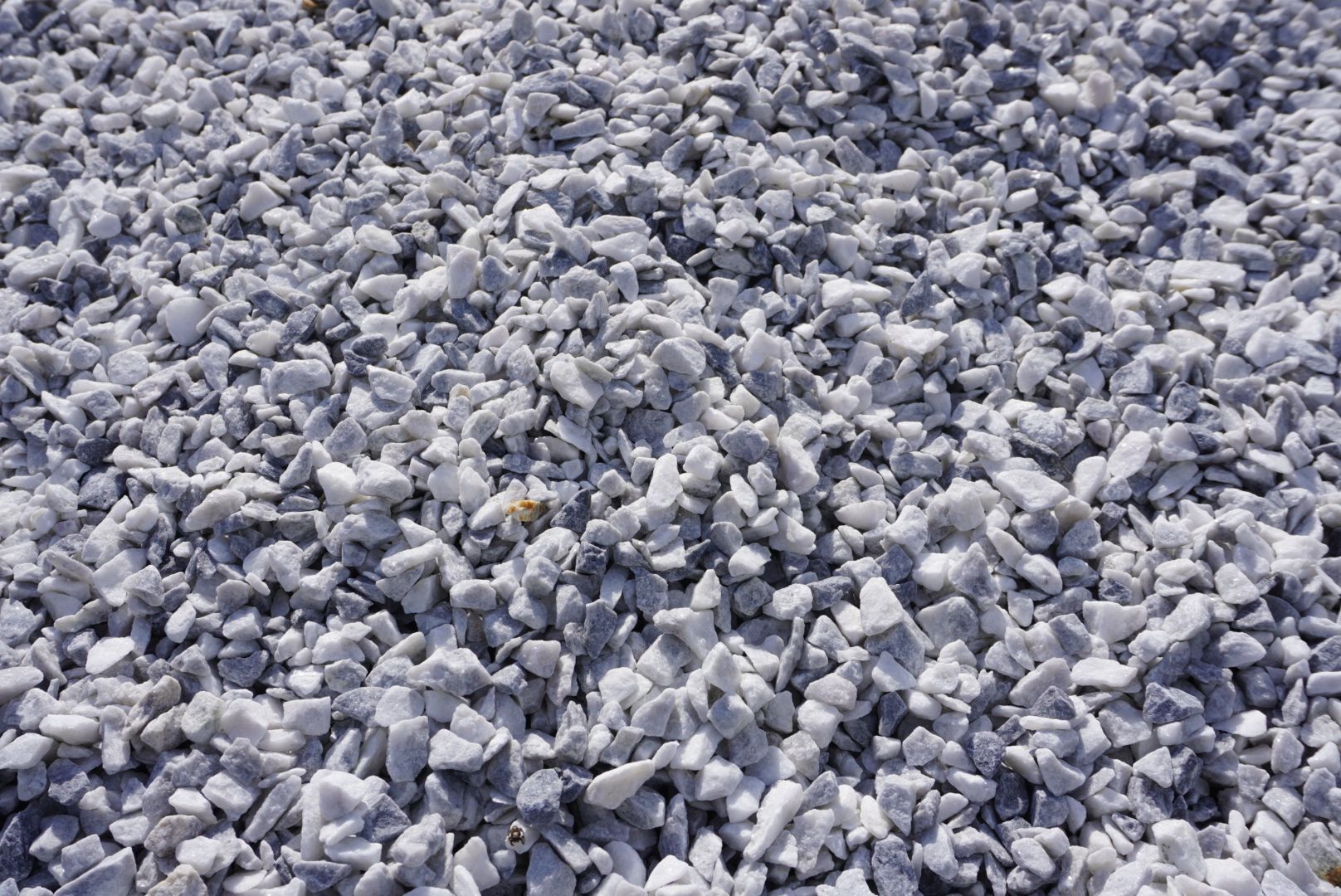 Pile of small gray rocks or gravel filling the frame