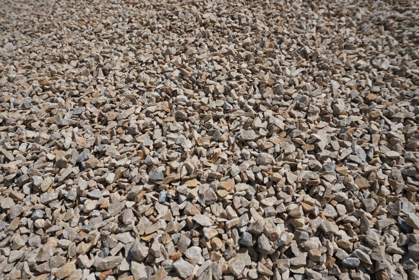 Pile of small tan and gray rocks covering the ground