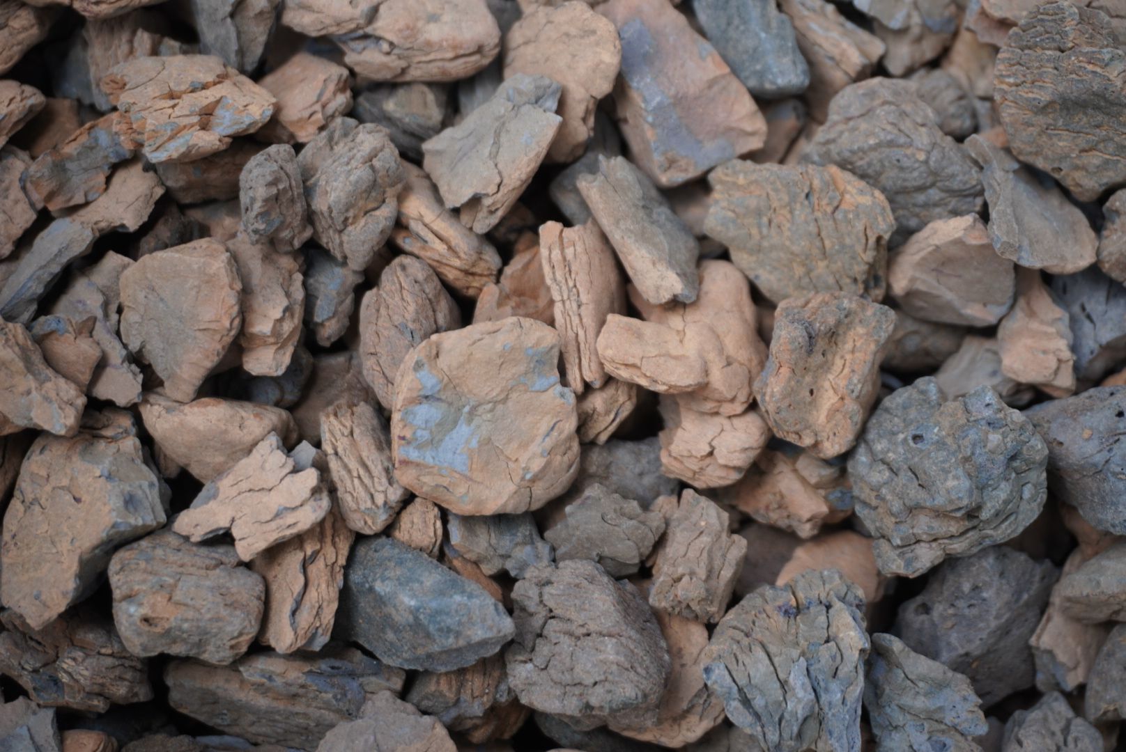 Pile of rough brown and gray rocks filling the frame