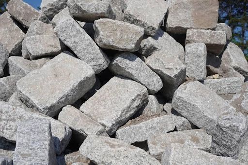 Pile of gray rocks stacked outdoors