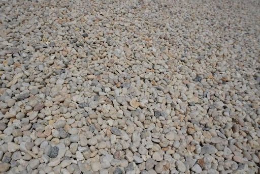 Close-up of a ground covered in small light-colored pebbles.
