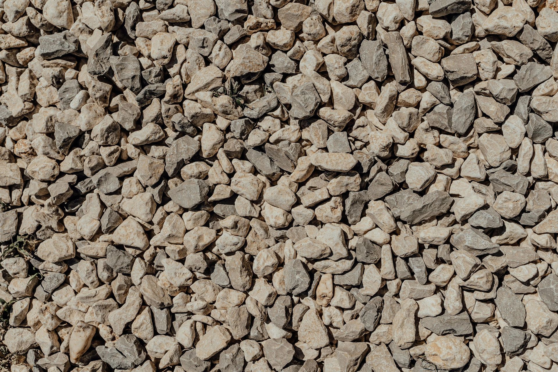Pile of small tan and gray gravel stones filling the frame
