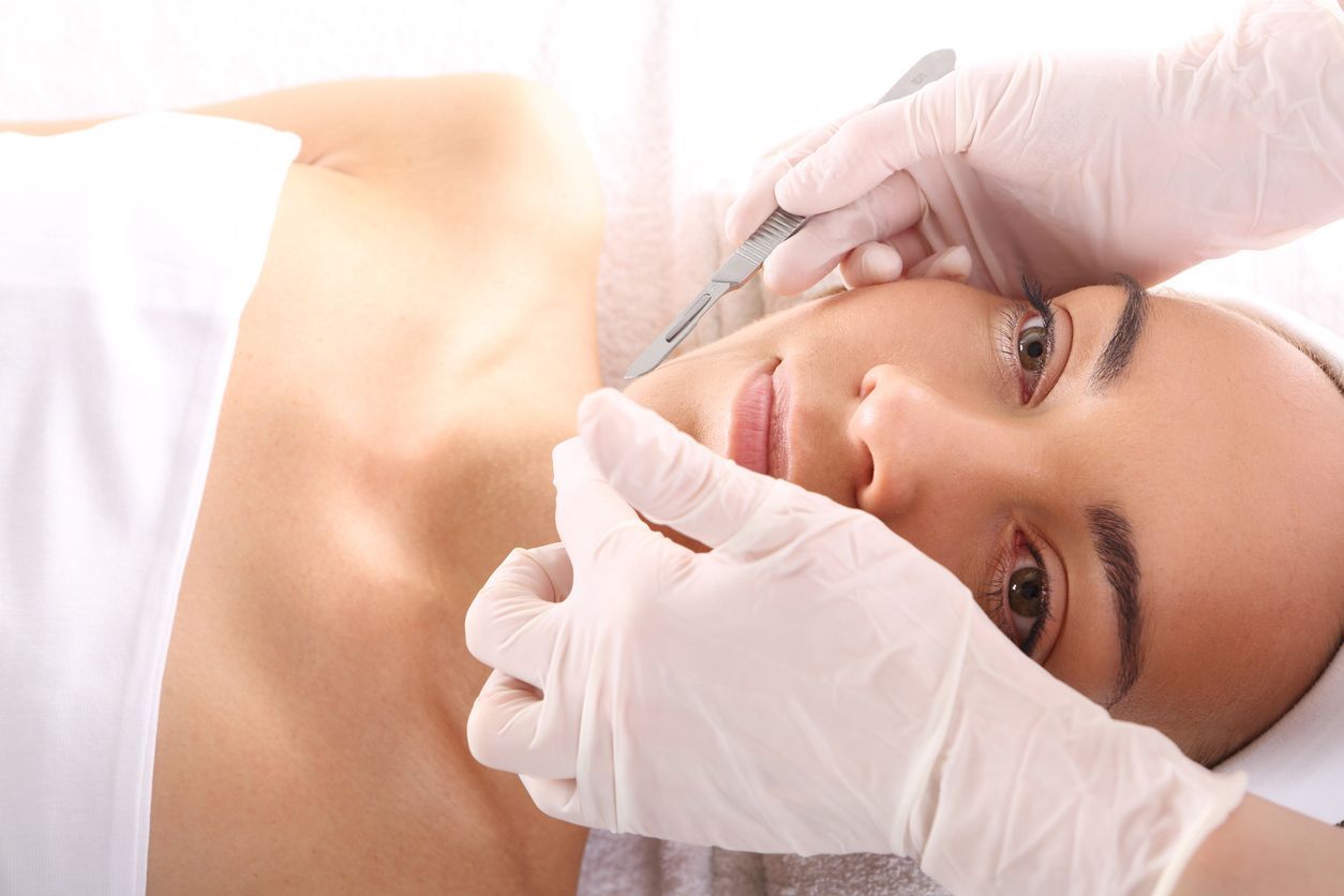A woman is getting a facial treatment at a spa.