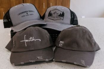 A group of baseball caps are sitting on top of a counter.