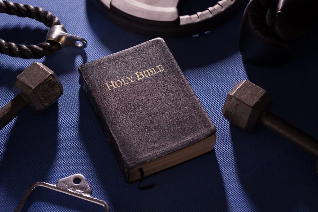 A holy bible sits on a blue cloth