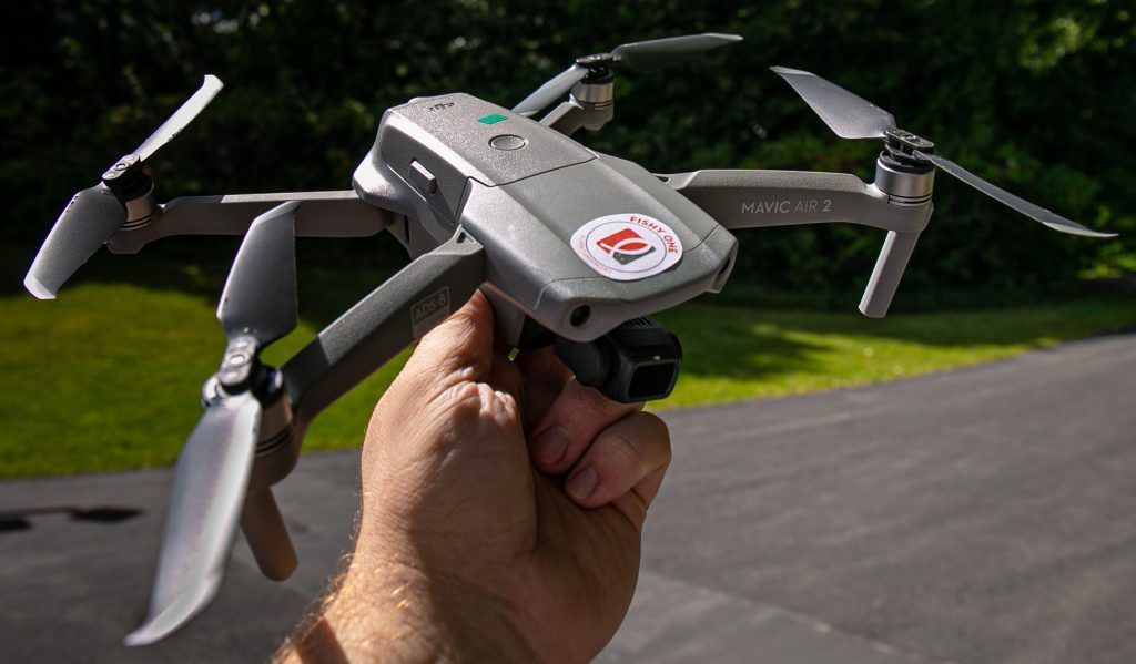 A person is holding a drone in their hand.