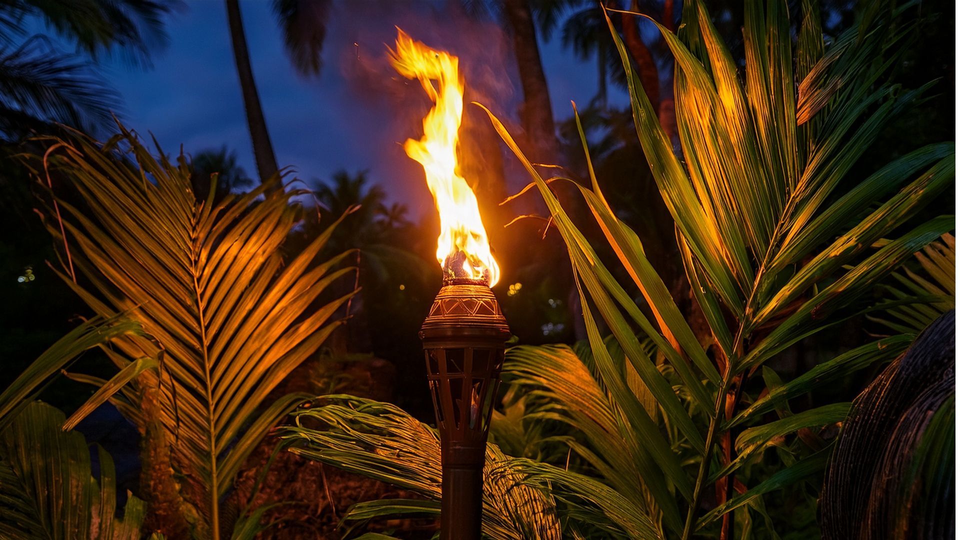 A torch is lit up in the middle of a tropical forest.