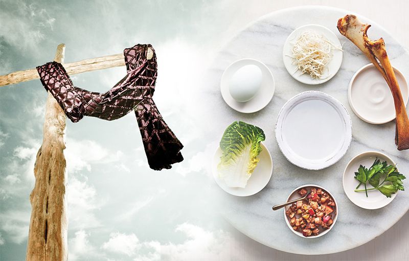 A cross with a scarf hanging from it next to a plate of food.