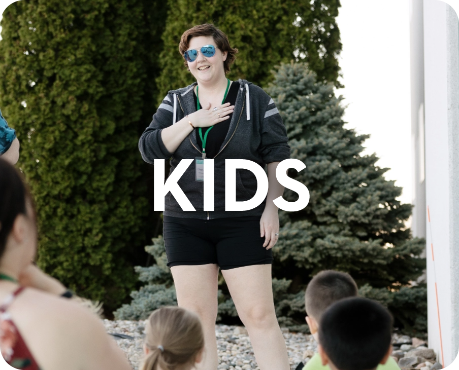 A woman is standing in front of a group of children with the word kids above her.