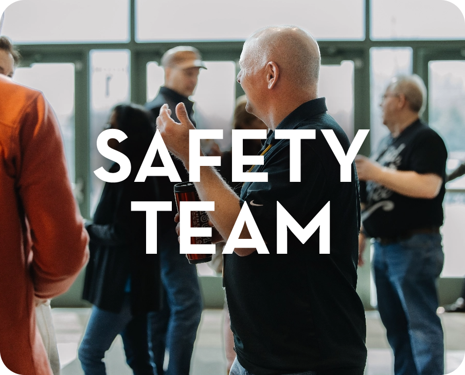A group of people are standing in a room with the words safety team written on the bottom.