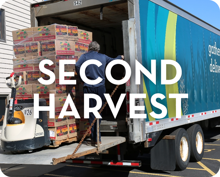 A man is loading boxes into the back of a semi truck.