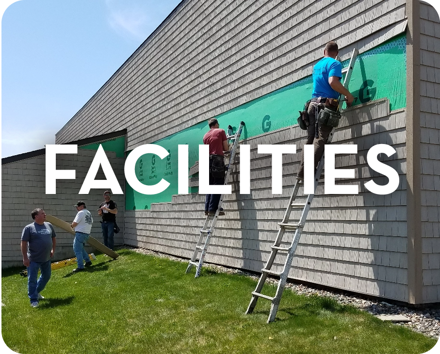 A group of people are working on the side of a building.