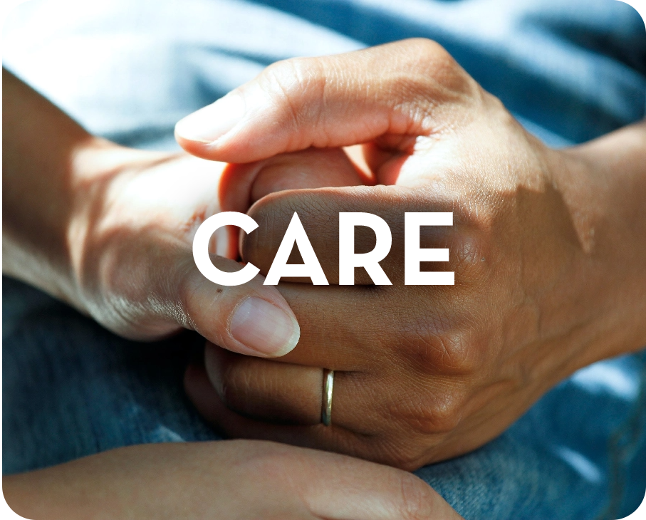 A person is holding another person 's hand with the word care on it.