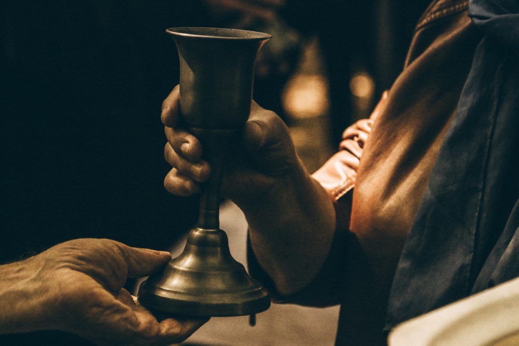 A person is holding a wine glass in their hand.