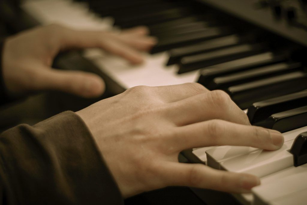 A close up of a person playing a piano