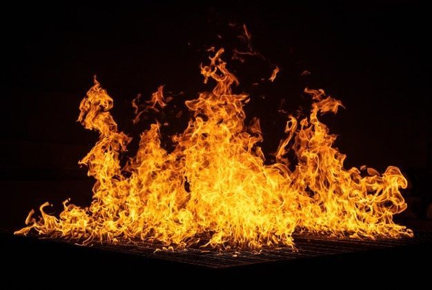 A large pile of fire flames on a black background.