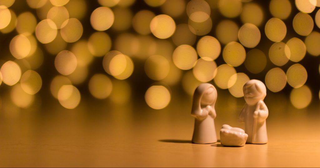 A nativity scene with figurines of jesus , mary and baby jesus on a table.